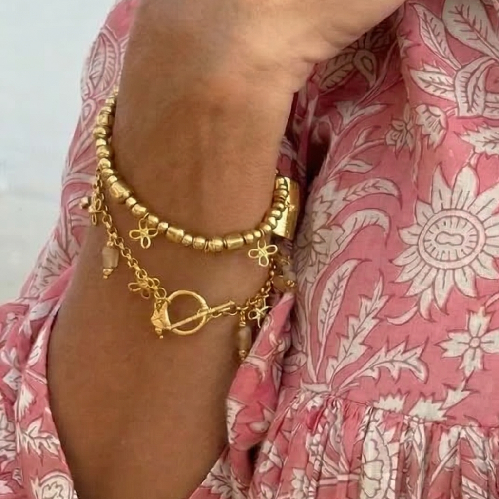 Gold beaded bracelet with flower charms