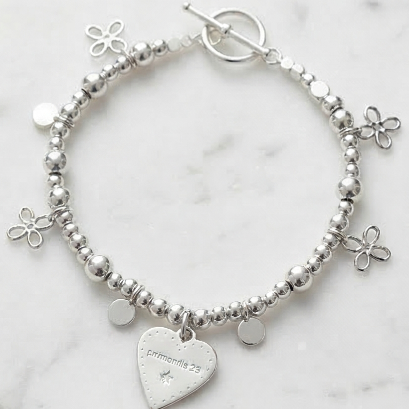 Silver beaded bracelet with flower charms