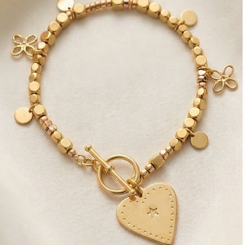 Gold beaded bracelet with flower charms