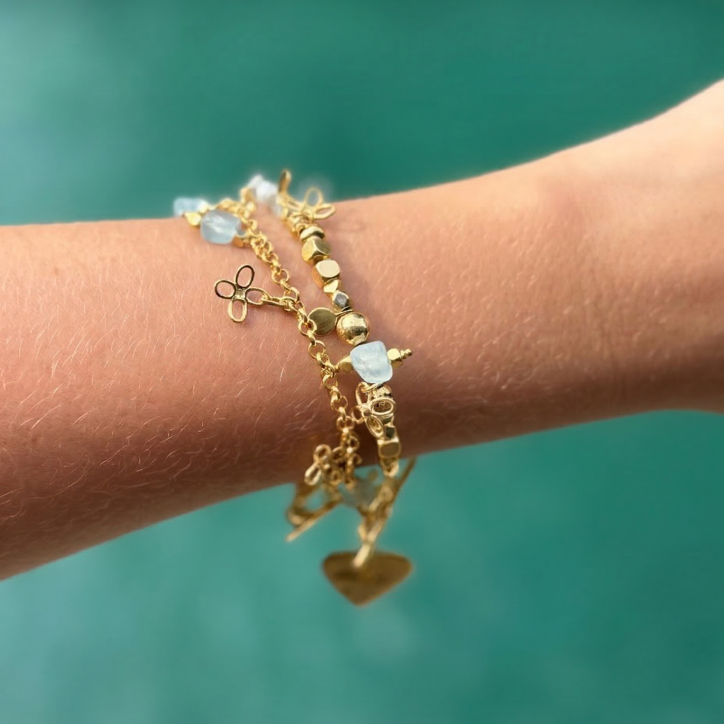 Gold beaded bracelet with flower charms