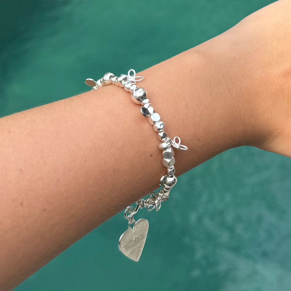 Silver beaded bracelet with flower charms