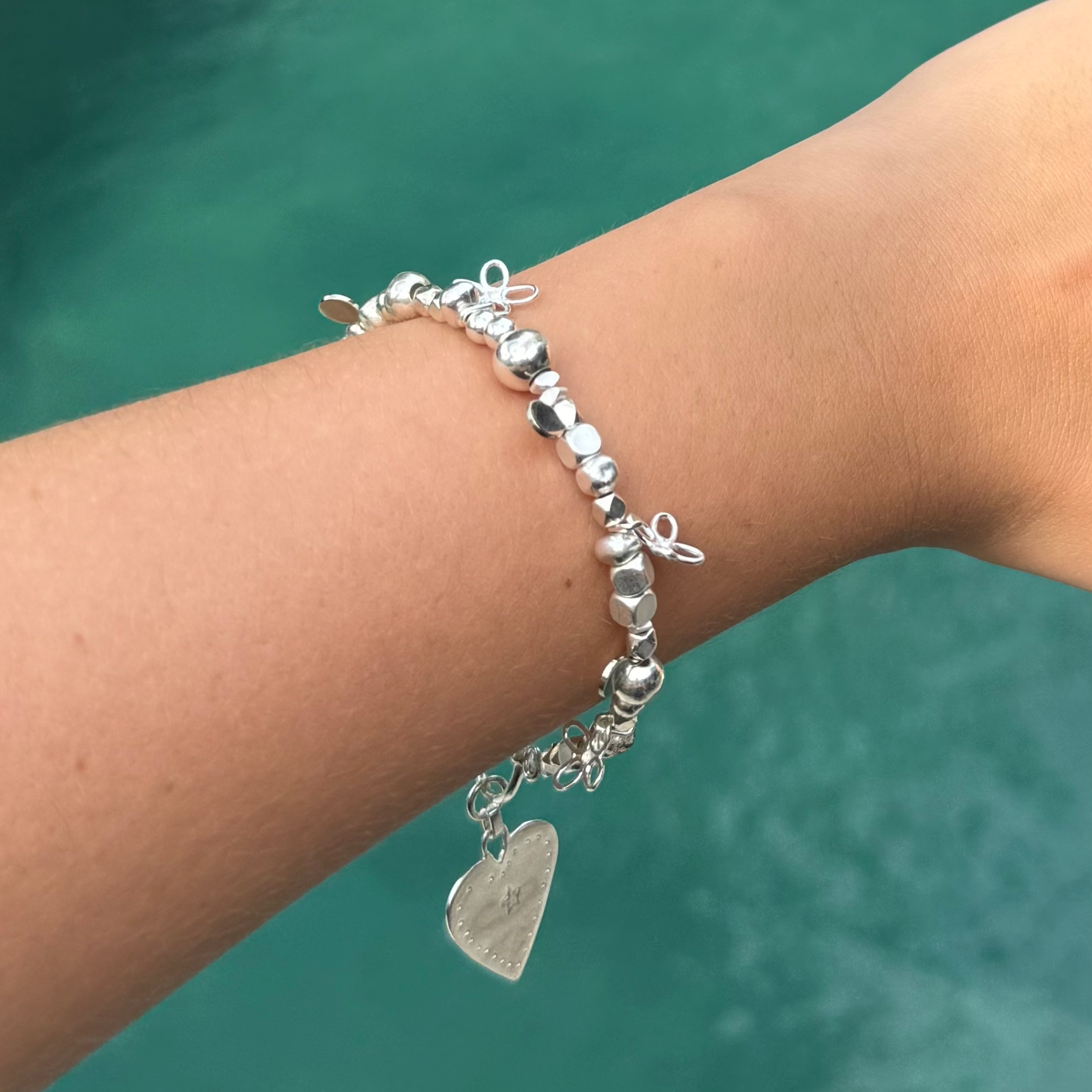 Silver beaded bracelet with flower charms