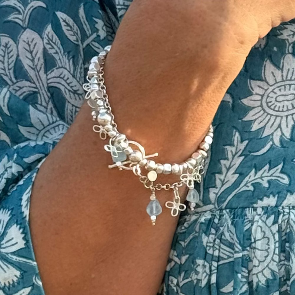 Silver beaded bracelet with flower charms